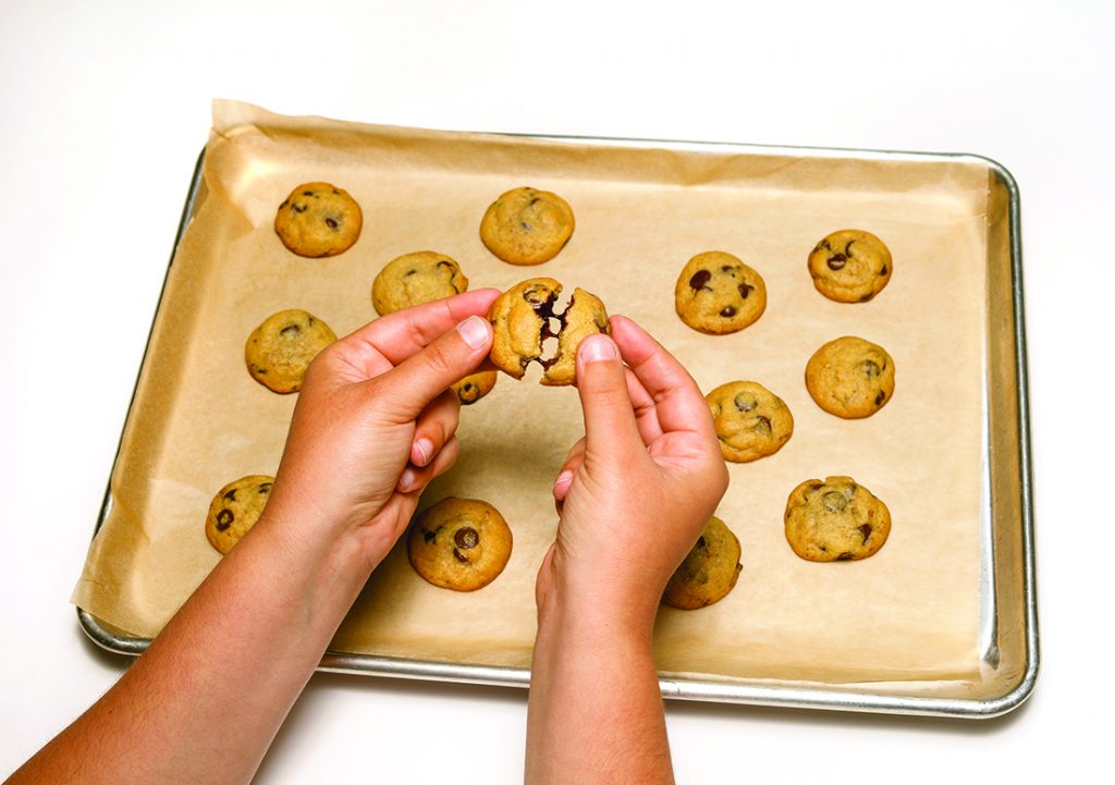 A batch of freshly baked cookies on a baking sheet.